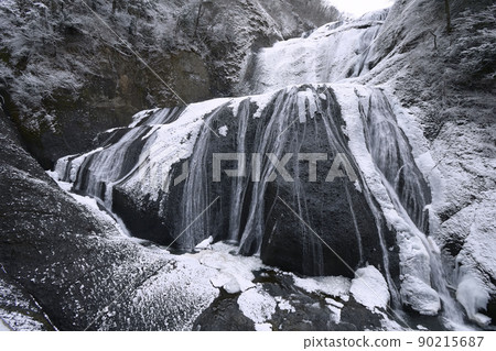Fukuroda Falls in the middle of winter with snow makeup seen up close from the waterfall 90215687