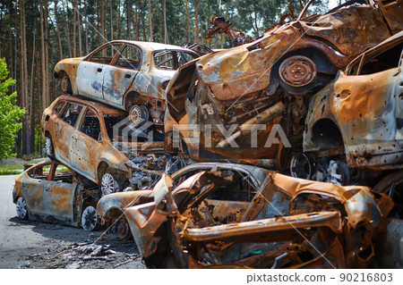A lot of rusty burnt cars in Irpen, after being shot by the Russian military. Russia's war against Ukraine. Cemetery of destroyed cars of civilians who tried to evacuate from the war zone 90216803
