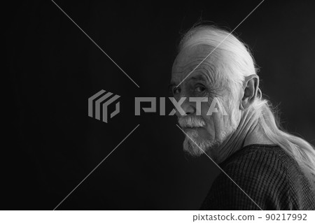 Black and white portrait of old alone man. 90217992