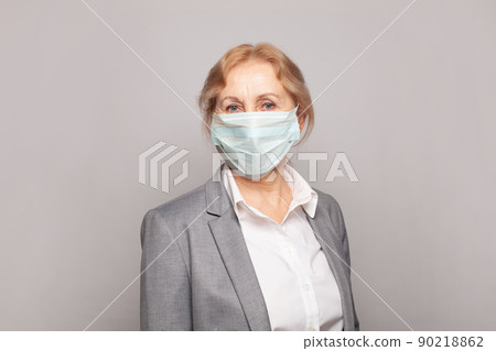 Doctor, medical worker or physician mature woman in medical mask on gray wall banner background Doctor, medical worker or physician mature woman in medical mask on gray wall banner background 90218862