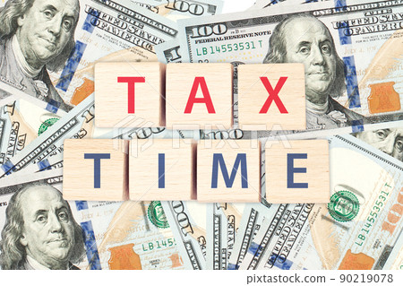 Tax time concept. Tax with pile of 100 us dollar banknotes background. Tax time concept. Tax with pile of 100 us dollar banknotes background. 90219078