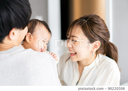 A baby who is happy to be hugged by his dad 90220306