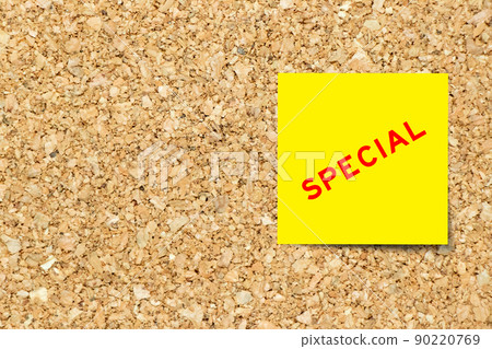 Yellow note paper with word special on cork board background with copy space 90220769