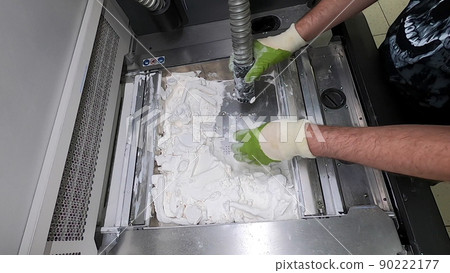 Man cleans details printed on industrial 3D printer from white plastic powder. Automated additive technologies. Person cleans vacuum cleaner plastic powder from models printed on 3D printer. Man cleans details printed on industrial 3D printer from white plastic powder. Automated additive technologies. Person cleans vacuum cleaner plastic powder from models printed on 3D printer. 90222177