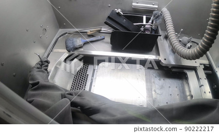 Worker in isolated rubber gloves takes screwdriver and unscrews platform inside working chamber of 3d printer for metal. Laser Sintering Machine for Metal. POV. Metal 3D printer. Additive technology Worker in isolated rubber gloves takes screwdriver and unscrews platform inside working chamber of 3d printer for metal. Laser Sintering Machine for Metal. POV. Metal 3D printer. Additive technology 90222217