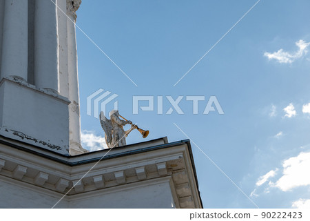 an angel with trumpet with blue sky as background an angel with trumpet with blue sky as background 90222423