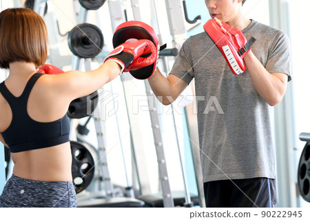 Male trainer and female customer holding a mitt Male trainer and female customer holding a mitt 90222945