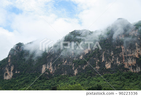 mountain view with fog after the rain in rainy season mountain view with fog after the rain in rainy season 90223336
