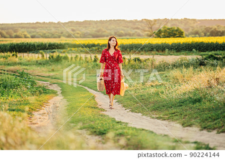 Countryside improve mental health. Rural mental health. Relaxing countryside break in rural cottage. Back view of Woman in red dress on nature background 90224144