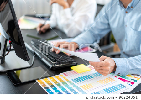 Two creative graphic designer team working on color selection and drawing on graphic tablet, Color swatch samples chart for selection coloring in inspiration to creativity at workplace Two creative graphic designer team working on color selection and drawing on graphic tablet, Color swatch samples chart for selection coloring in inspiration to creativity at workplace 90224351