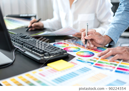 Team of creative graphic designer working on color swatch samples chart for selection coloring in inspiration to create new collection at workplace 90224354