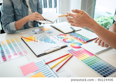 Two creative graphic designer team working on color selection and drawing on graphic tablet, Color swatch samples chart for selection coloring in inspiration to creativity at workplace Two creative graphic designer team working on color selection and drawing on graphic tablet, Color swatch samples chart for selection coloring in inspiration to creativity at workplace 90224406