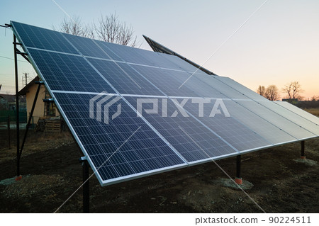 Solar photovoltaic panels for producing of clean ecological electrical energy mounted on backyard ground in suburban rural area. Concept of autonomous home 90224511