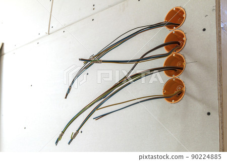 New electrical installation, socket plastic boxes and electrical cables on the wall, renovation concept. Electrical wiring installation. New electrical installation, socket plastic boxes and electrical cables on the wall, renovation concept. Electrical wiring installation. 90224885