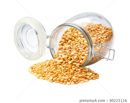 Raw dried peas spill out of a glass storage jar isolated on white background. Raw dried peas spill out of a glass storage jar isolated on white background. 90225116