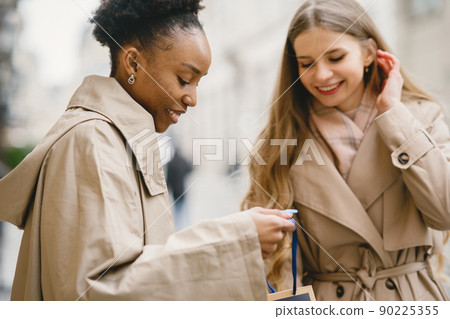 Shopping day. International girlfriends. Women in a city. 90225355