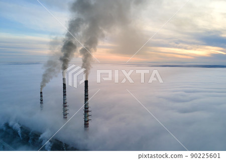 Coal power plant high pipes with black smoke moving upwards polluting atmosphere. Production of electrical energy with fossil fuel concept 90225601