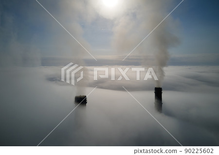 Coal power plant high pipes emitting black poisonous smoke moving upwards over white fog polluting air. Production of electrical energy with fossil fuel concept Coal power plant high pipes emitting black poisonous smoke moving upwards over white fog polluting air. Production of electrical energy with fossil fuel concept 90225602