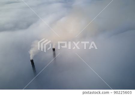 Coal power plant high pipes emitting black poisonous smoke moving upwards over white fog polluting air. Production of electrical energy with fossil fuel concept Coal power plant high pipes emitting black poisonous smoke moving upwards over white fog polluting air. Production of electrical energy with fossil fuel concept 90225603