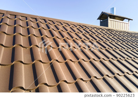 Closeup of house roof top covered with metallic shingles 90225623