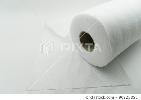 Universal white fabric napkins for cleaning in a roll. Bobbin with napkins for dispenser. Selective focus 90225853