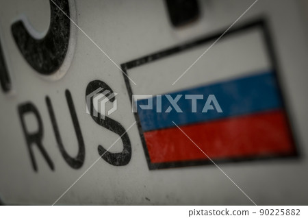 The image of the Russian flag on the registration number of the car. RUS region. Selective focus The image of the Russian flag on the registration number of the car. RUS region. Selective focus 90225882
