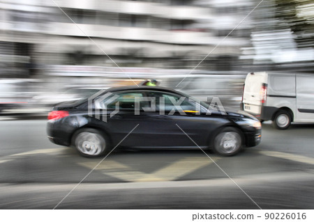 Car moving fast across the street 90226016