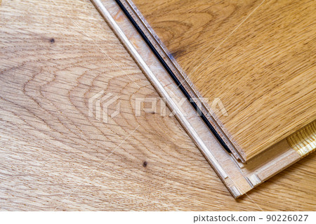 Brown wooden parquet floor planks installation , close up. Carpentry concept. Brown wooden parquet floor planks installation , close up. Carpentry concept. 90226027