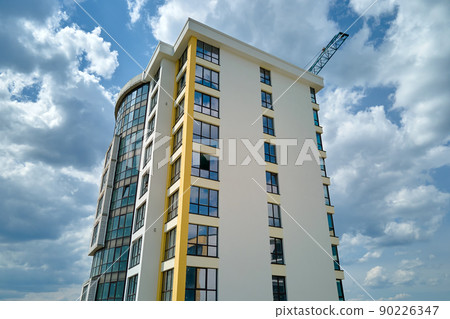 Architectural details of modern high apartment building facade with many windows and balconies 90226347