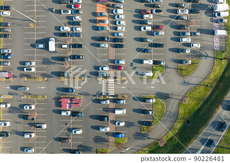 Aerial view of many colorful cars parked on parking lot with lines and markings for parking places and directions 90226481