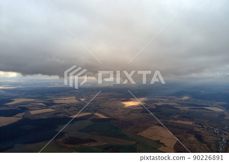Aerial view from high altitude of earth covered with puffy rainy clouds forming before rainstorm Aerial view from high altitude of earth covered with puffy rainy clouds forming before rainstorm 90226891
