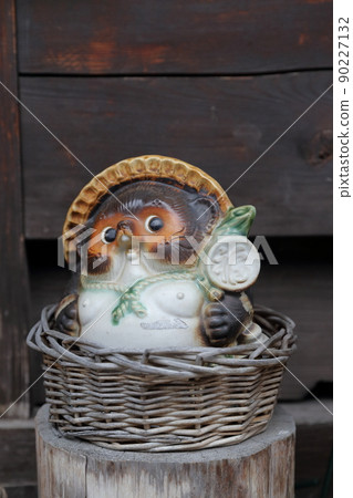A lucky raccoon dog figurine placed at the storefront (Narai-juku, Shiojiri City, Nagano Prefecture) 90227132
