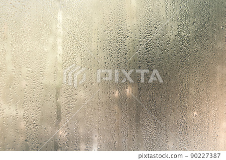 Condensate drops on the glass of a plastic window. Freezing and the formation of condensation and mold on the new plastic window. Defect in installation. Problem. Selective focus Condensate drops on the glass of a plastic window. Freezing and the formation of condensation and mold on the new plastic window. Defect in installation. Problem. Selective focus 90227387
