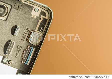 Close-up of the smartphone without a back cover. Slots for SIM cards. Selective focus 90227415