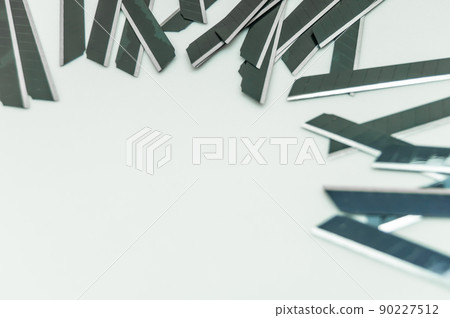New black blades for stationery knife. A pack of spare stationery blades. Selective focus, copy space New black blades for stationery knife. A pack of spare stationery blades. Selective focus, copy space 90227512