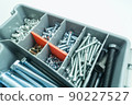 Box organizer for storing bolts of different sizes and other metal fasteners for repairs in the house and workshop. Close-up tool box. Selective focus 90227527