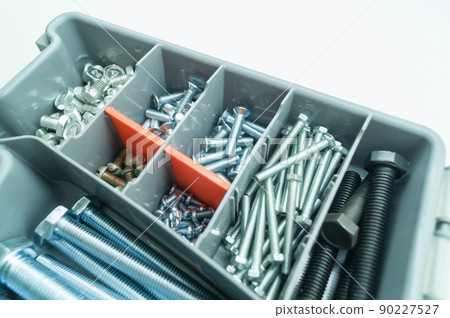 Box organizer for storing bolts of different sizes and other metal fasteners for repairs in the house and workshop. Close-up tool box. Selective focus 90227527