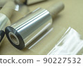Thermal transfer ribbon - TTR. Wax thermo ribbon on cardboard reel for barcode. Supply material for printing industry. Selective focus 90227532
