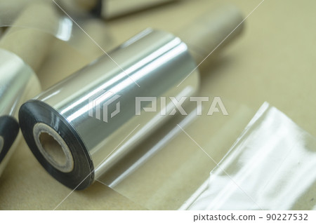 Thermal transfer ribbon - TTR. Wax thermo ribbon on cardboard reel for barcode. Supply material for printing industry. Selective focus Thermal transfer ribbon - TTR. Wax thermo ribbon on cardboard reel for barcode. Supply material for printing industry. Selective focus 90227532