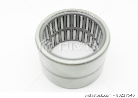 Needle bearing on a white background. Roller bearing for motors, machinery and equipment. Spare part. Selective focus, isolated on white Needle bearing on a white background. Roller bearing for motors, machinery and equipment. Spare part. Selective focus, isolated on white 90227540