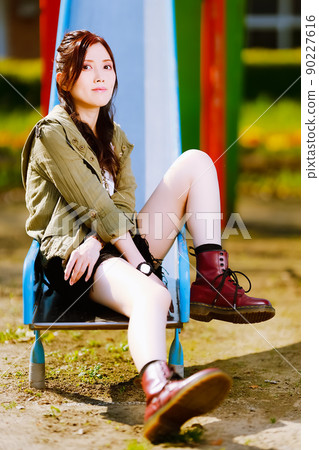A cute female portrait on a slide in an abandoned elementary school A cute female portrait on a slide in an abandoned elementary school 90227616
