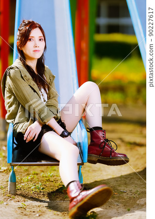 A cute female portrait on a slide in an abandoned elementary school A cute female portrait on a slide in an abandoned elementary school 90227617