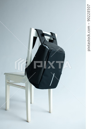 modern stylish backpack on chair studio shot 90228507
