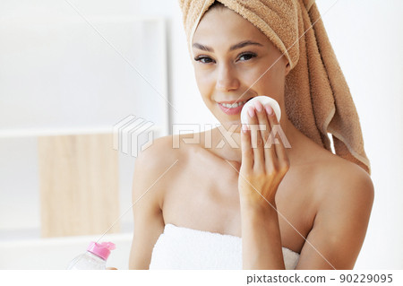 Pretty young lady doing daily morning skincare procedures 90229095