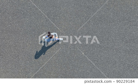 Aerial view of a woman jogging Aerial view of a woman jogging 90229184