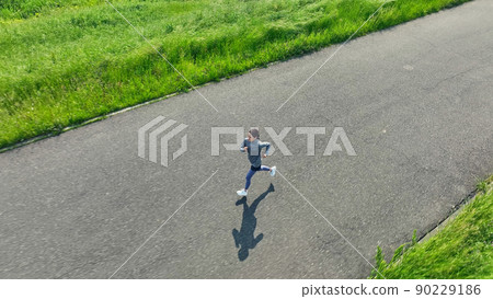 Aerial view of a woman jogging Aerial view of a woman jogging 90229186