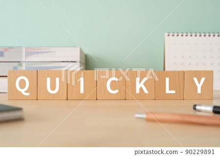 Desk with building blocks with "QUICKLY" written on it Desk with building blocks with "QUICKLY" written on it 90229891