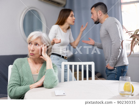 Mature woman waiting for couple stop quarreling Mature woman waiting for couple stop quarreling 90230335