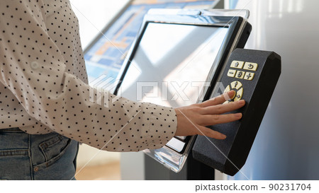 A woman uses a voting device for blind and visually impaired citizens. A woman uses a voting device for blind and visually impaired citizens. 90231704