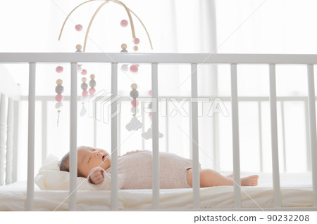 Baby sleeping under a mobile one month old 90232208